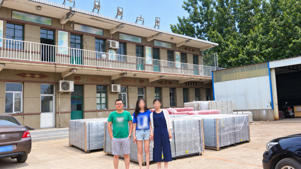 Harry Lee at a fence factory in Hengshui Hebei in 2015 with finished fence panels behind him