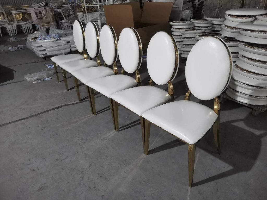 Wedding chairs with stainless steel frames and white PU upholstery at a factory