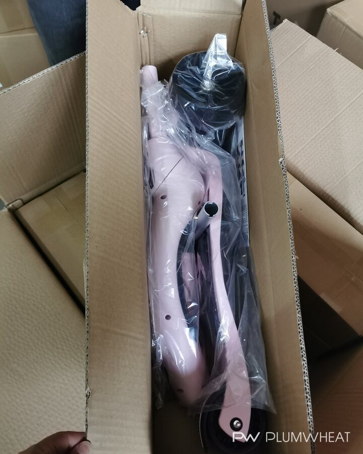 Disassembled children's scooter protected inside an export carton.