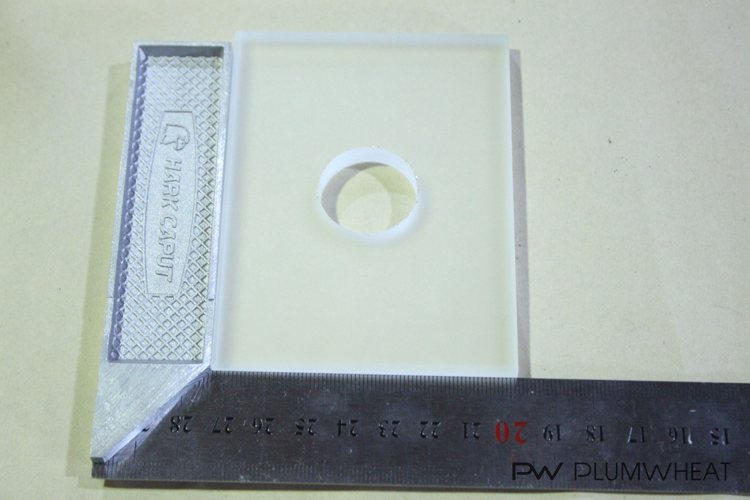 LED glass component checked against measuring tools during quality inspection