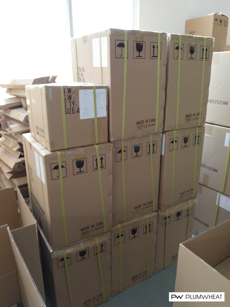Stacked cartons of downlight housings at a factory in China