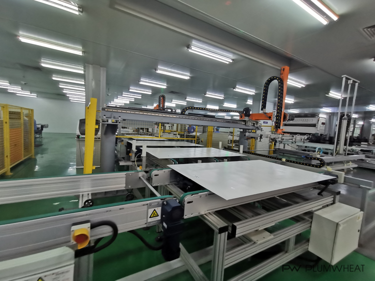 Automated solar module production equipment during a factory audit in China