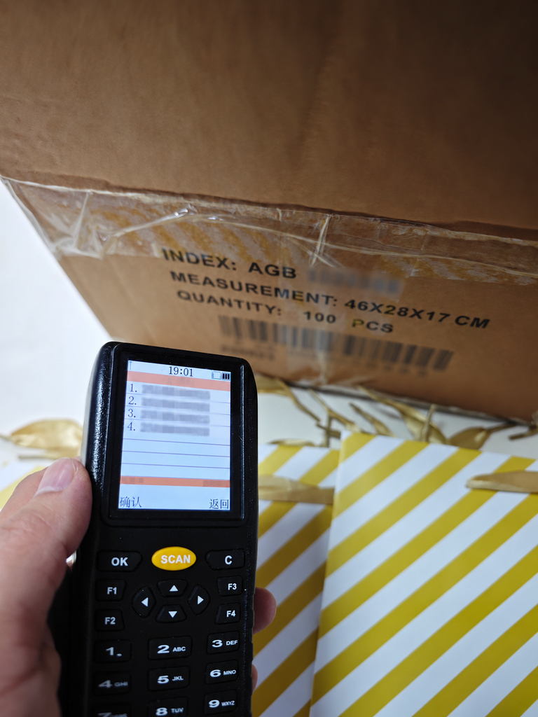 Handheld scanner testing whether product barcodes can be read correctly during inspection.