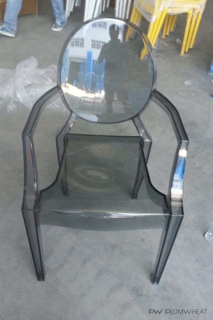 Smoky grey PW855 transparent chair photographed during product handling