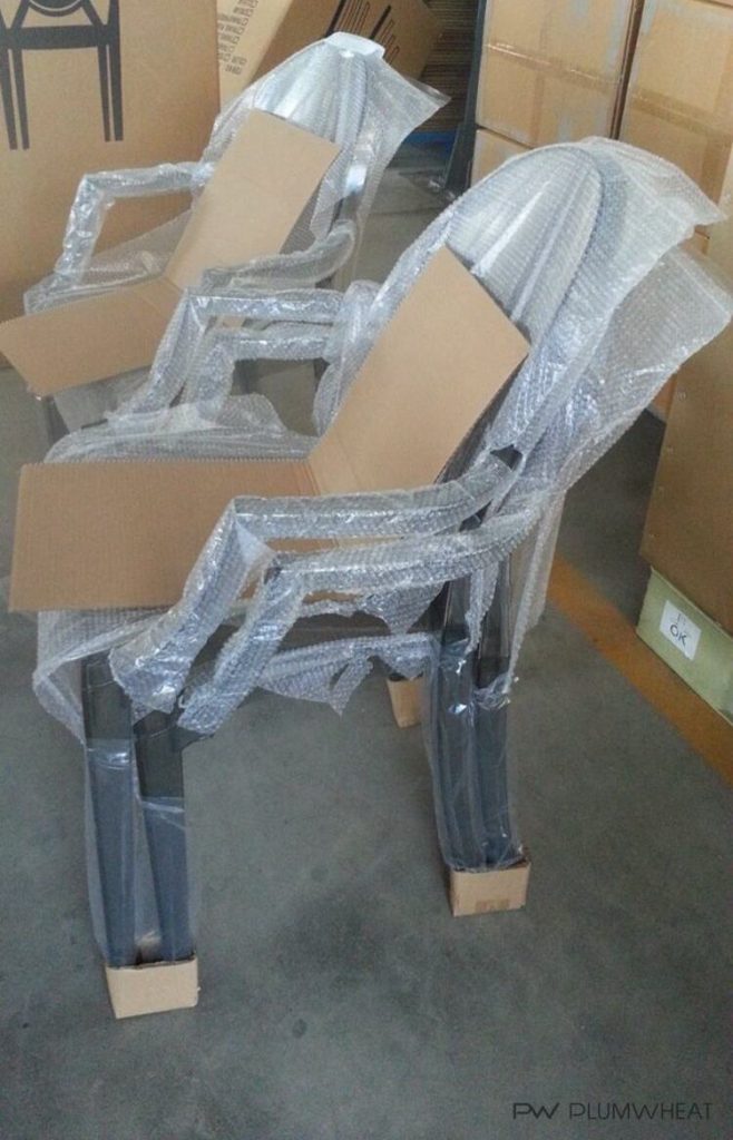 PW855 chairs stacked with protective wrapping before packing