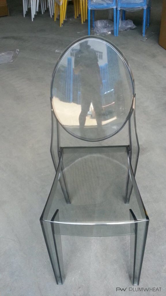 Smoky grey PW884 transparent chair photographed during product handling